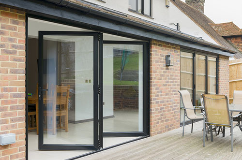 Modern bifold doors installation by Access Garage Doors, offering stylish and functional entryways