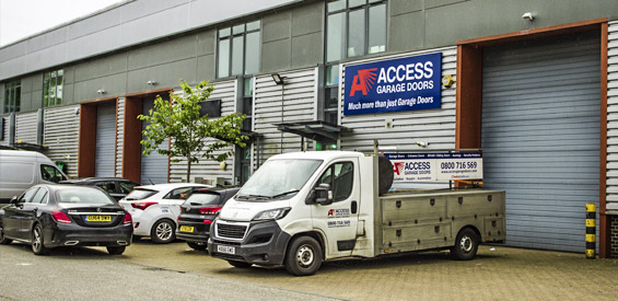 Access Garage Doors showroom with service van, showcasing garage doors and related services