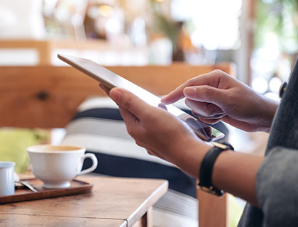 Customer browsing garage door options on a tablet, provided by Access Garage Doors