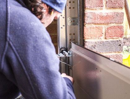 Access Garage Doors technician installing components for a new garage door