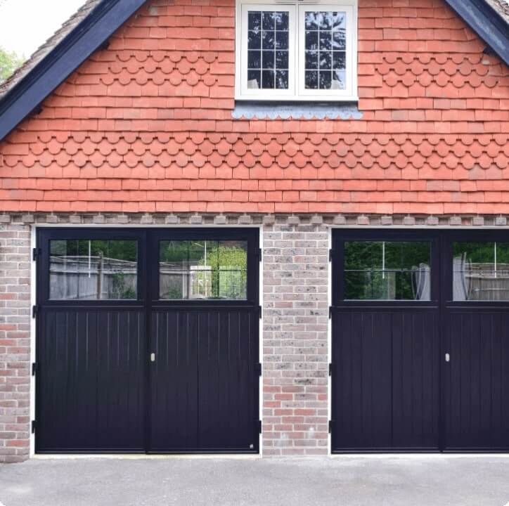 Classic black garage doors with windows, installed by Access Garage Doors for a stylish home