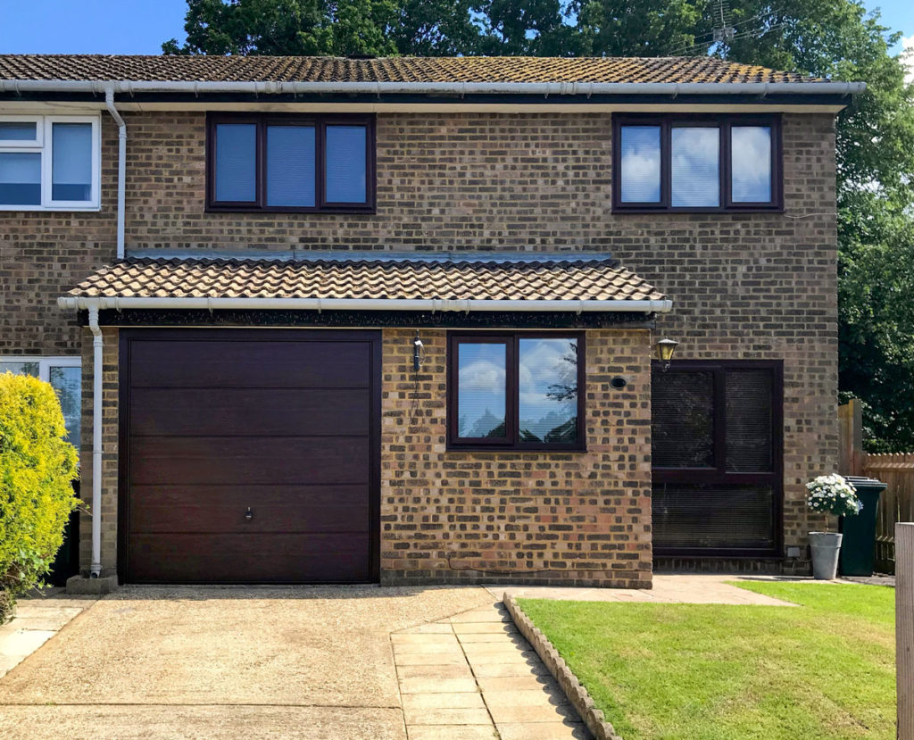 A Hormann Horizontal Decograin Canopy Garage Door finished in Rosewood