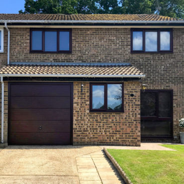 A Hormann Horizontal Decograin Canopy Garage Door finished in Rosewood