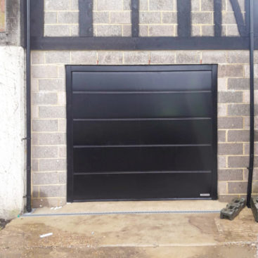 A Hormann LPU42 L-Ribbed Automated Sectional Garage Door finished in Black