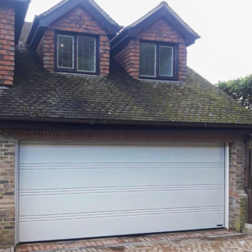 A Hormann LPU42 T-Ribbed Automated Sectional Garage Door finished in Light Grey
