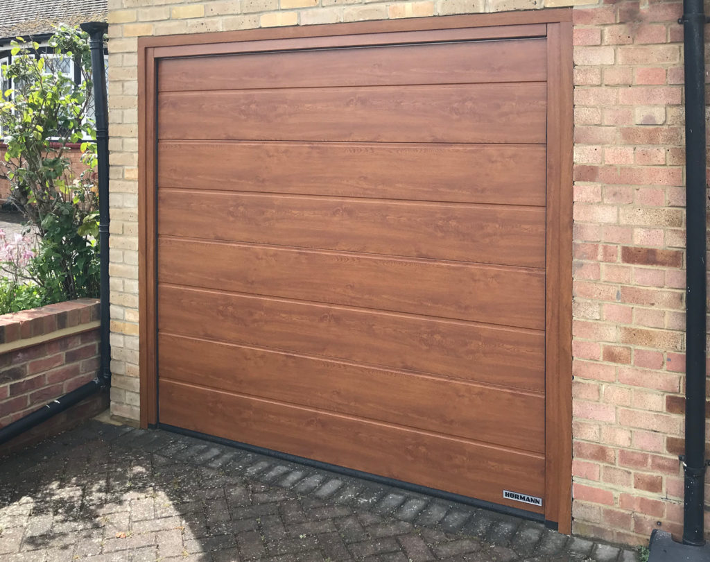 Hormann LPU42 M-Ribbed Sectional Garage Door finished in Golden Oak Decograin