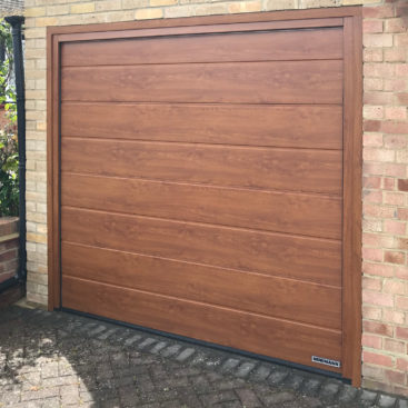 Hormann LPU42 M-Ribbed Sectional Garage Door finished in Golden Oak Decograin