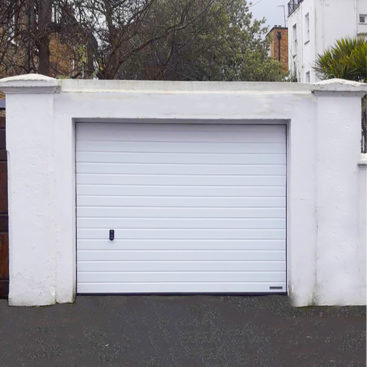 Hormann LPU 42 S-Ribbed Sectional Garage Door finished in a Traffic White Wood Grain