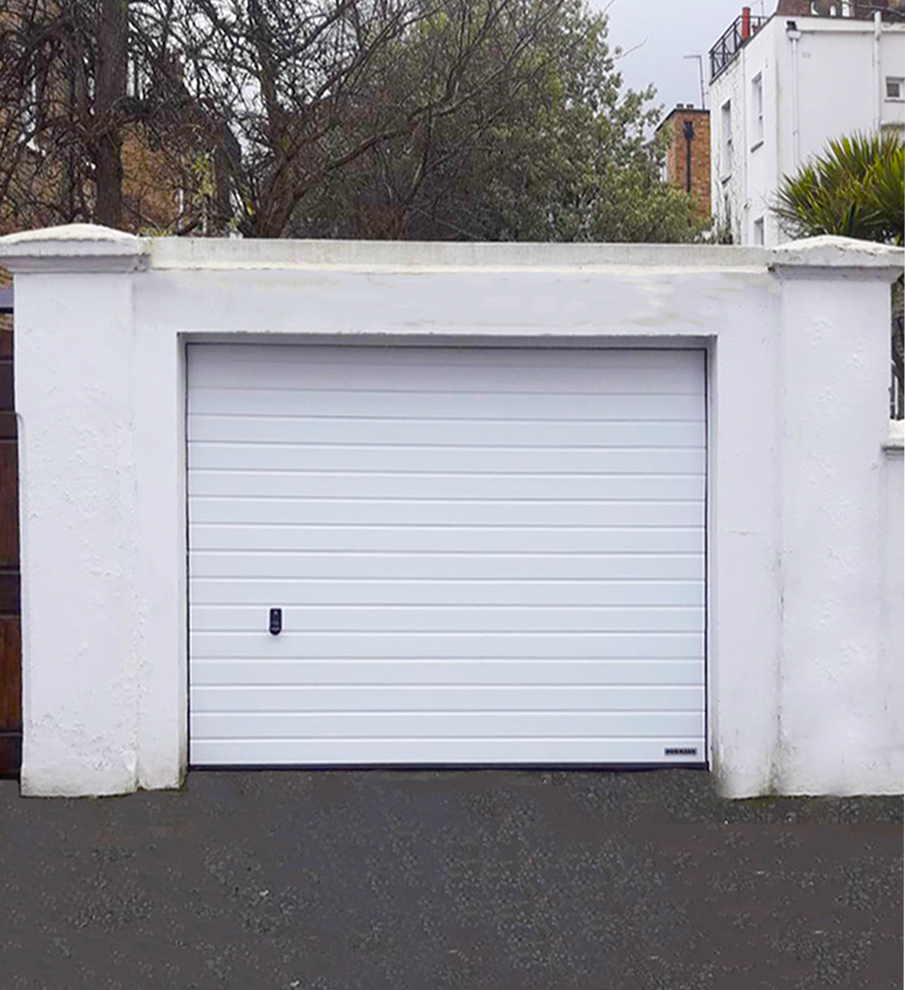 Hormann LPU 42 S-Ribbed Sectional Garage Door finished in a Traffic White Wood Grain