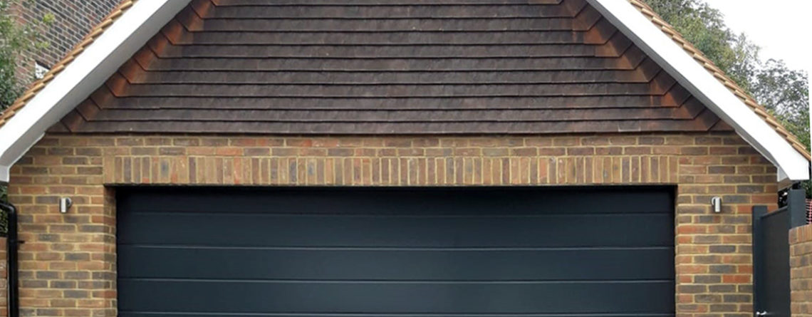 M Ribbed Hormann Sectional Garage Door In Night Oak Insulated And Remote Control For That Touch Of Luxury And Style Sectional Garage Doors Doors Garage Doors