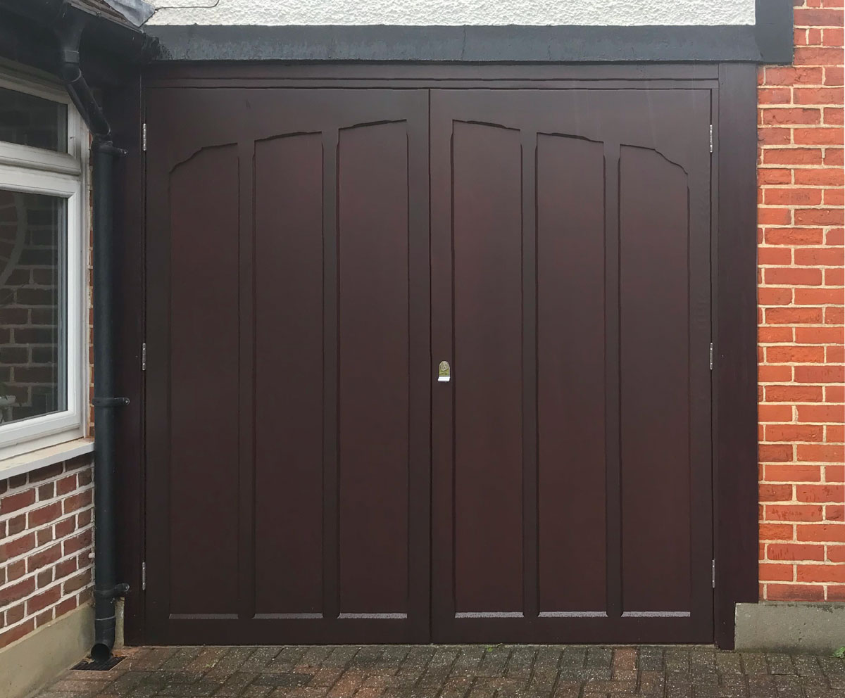 A Woodrite Twickenham Side Hinged Garage Door finished in Mahogany