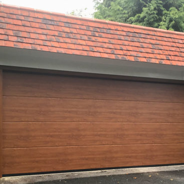 Hormann LPU42 L Ribbed Garage Door in Golden Oak