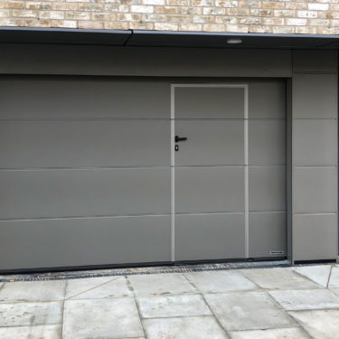 Hormann M-ribbed sectional garage door with wicket door