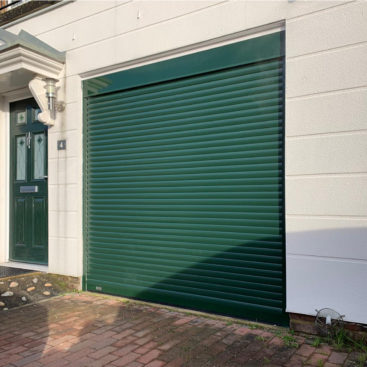 SeceuroGlide Fully Automated Compact Insulated Roller Garage Door finished In Fir Green