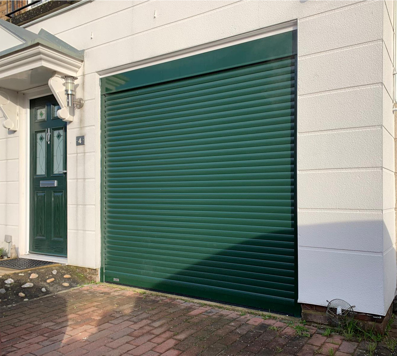 SeceuroGlide Fully Automated Compact Insulated Roller Garage Door finished In Fir Green
