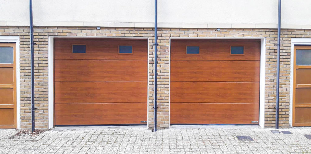 Hormann LPU42 L-Ribbed Insulated Sectional Garage Doors with Windows in Golden Oak Decograin