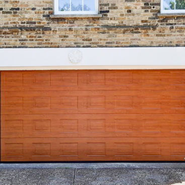 Hormann Georgian Sectional Garage door in Golden Oak Decograin